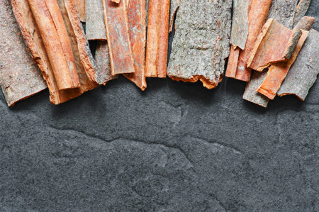 Cinnamon sticks on the dark background texturalの写真素材