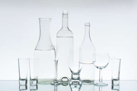 Glassware with clear water on the light backgroundの写真素材