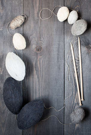 Skeins and knitting needles on the dark vintage tableの写真素材