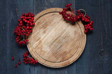 Red viburnum on the old wooden tableの写真素材