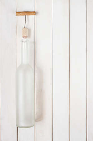 Matte glass bottle empty on the white wooden tableの写真素材
