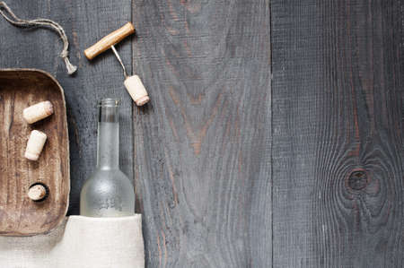 Vintage dark background with empty wine bottle and accessoriesの写真素材