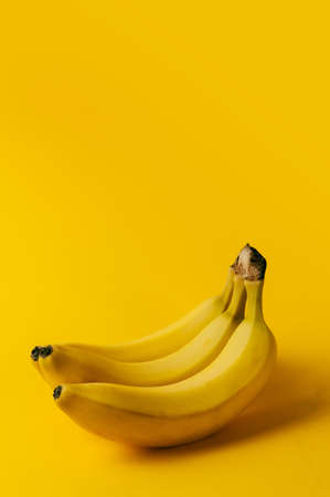 Ripe banana on the yellow backgroundの写真素材