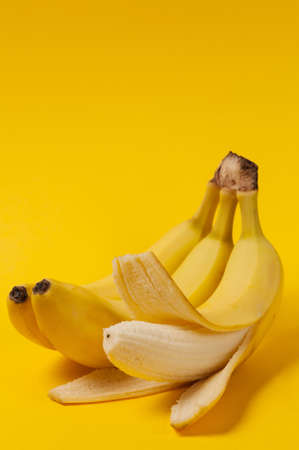 Ripe bananas on the yellow backgroundの写真素材
