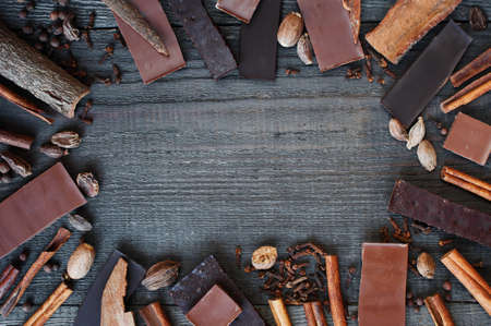 Wooden background with chocolate and spicesの写真素材