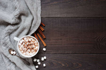 Wooden background with cup of cacao and marshmallowの写真素材