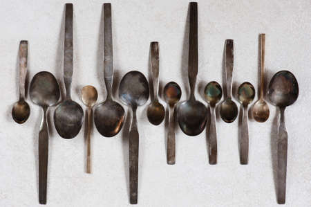 Vintage various spoons on the light tableの写真素材
