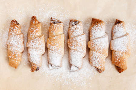 Six freshly baked cookies on baking paperの写真素材