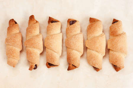 Six freshly baked cookies on baking paperの写真素材