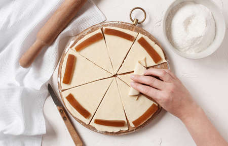 Women's hands prepare sweets on the kitchen tableの写真素材
