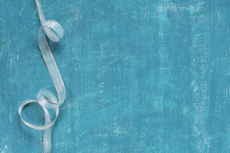 Painted aged blue background with silver ribbonの写真素材