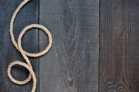 Rope on the old dark wooden backgroundの写真素材