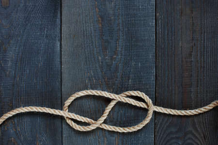 Knot of rope on the wooden backgroundの写真素材