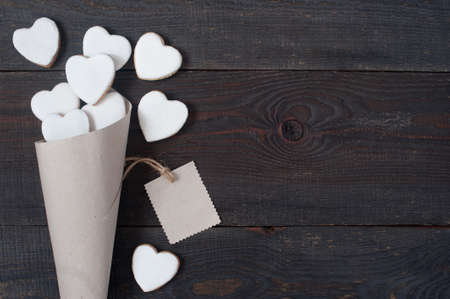 Background with packaged cookies-hearts with white icing, empty spaceの写真素材