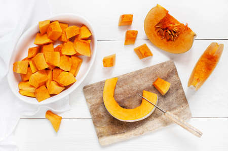 Slices pumpkin on the white wooden kitchen tableの写真素材