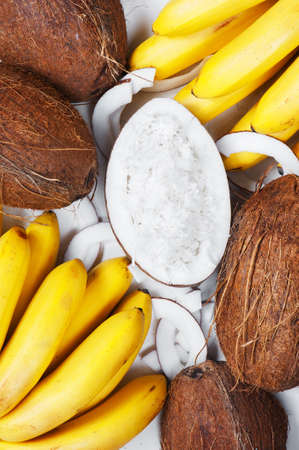 Coconuts and babanas on the tableの写真素材
