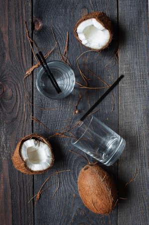 Coconut water and coconuts on the brown wooden tableの写真素材