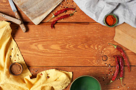 Wooden background with kitchen utensils and spicesの写真素材