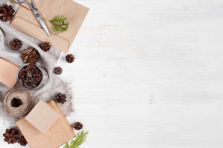 Light wooden holiday background with craft gift boxesの写真素材