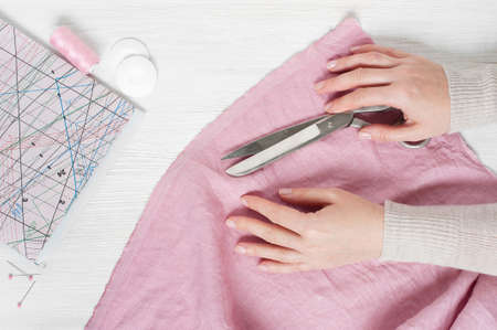 Famale hands holding the scissorsの写真素材