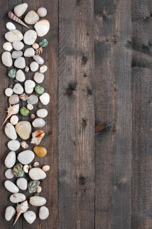 Wooden background with sea shells and pebbleの写真素材