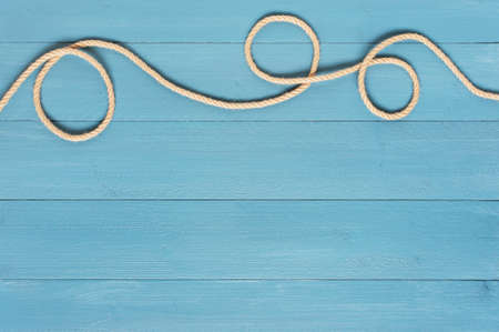 Blue wooden background with ropeの写真素材