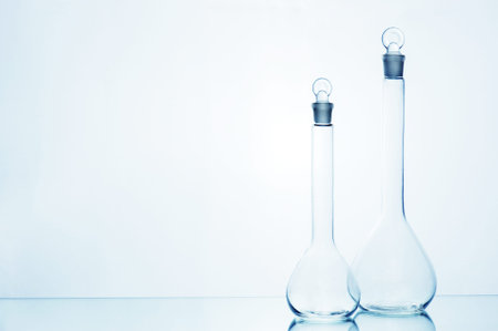 Two empty medicine transparent glass bottles on the mirror table, copy space
