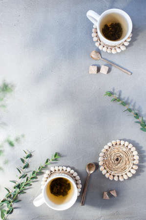 Two cups of tea on the gray table, sunny morning. Background with copy spaceの写真素材