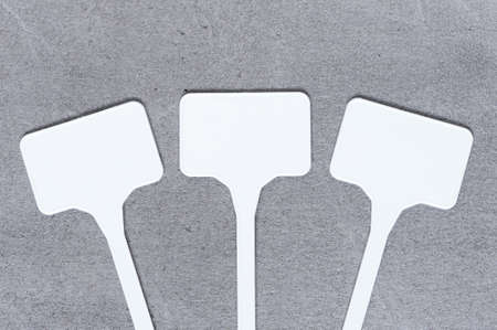 Three white blank labels on the textured gray cement surface. Copy spaceの写真素材