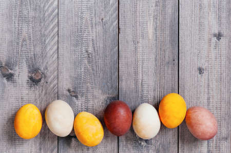 Background with Easter eggs on the gray wooden table, copy spaceの写真素材