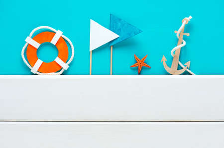 Blue background with handmade paper elements of marine decoration and white boards, copy spaceの写真素材