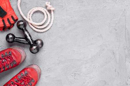 Sport glove, old shoes and small vintage dumbbell, black background with copy spaceの写真素材