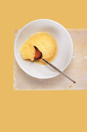 Portion of  lemon sorbet in the white bowl on stone stand , top viewの写真素材