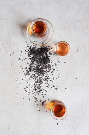 Glass cups with black tea on the textured grey table, top viewの写真素材