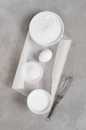 Ingredients for baking on the textured gray table. Top view