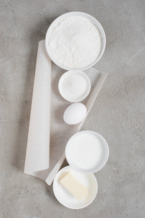 Ingredients for baking on the textured gray table. Top view