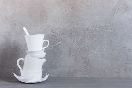 White crockery on the table against the textured grey wall, background with copy spaceの写真素材