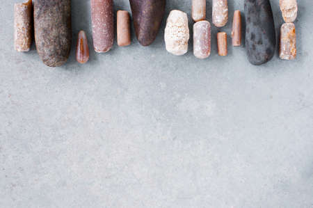 Background with various stones on the textured grey background, copy spaceの写真素材