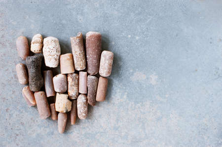 Heart made of stones on the textured grey background, copy spaceの写真素材