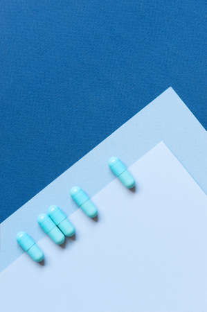 Blue background with pills, copy spaceの写真素材