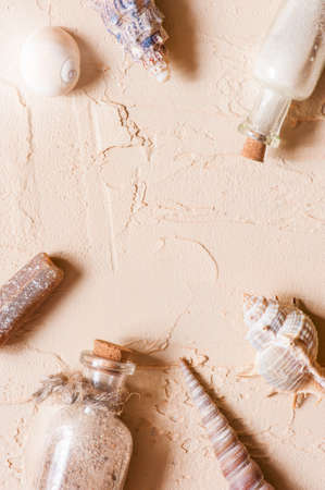 Textured background with seashells and glass bottles of sand, copy spaceの写真素材