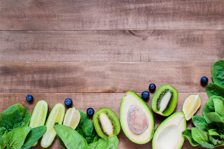 Wooden background with fresh healthy vegetables, fruits and berries, copy spaceの写真素材