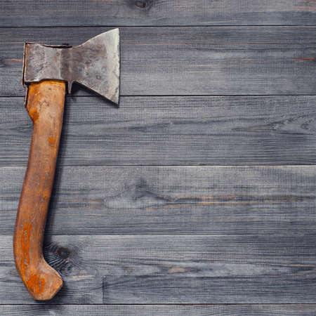 Dark gray background with old ax, copy spaceの写真素材