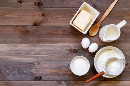Wooden brown background with ingredients for baking, copy spaceの写真素材