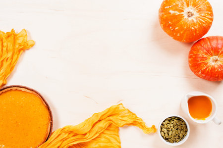 Background with fresh homemade pumpkin pie on the white wooden table, top viewの写真素材