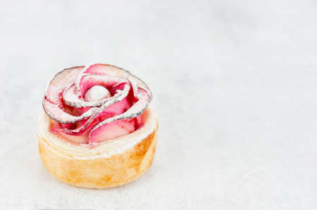 Beautiful apple rose cake coated with powdered sugar, copy spaceの写真素材