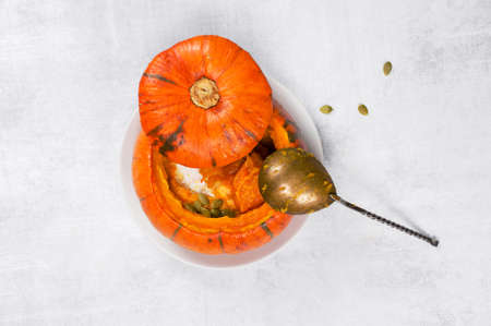 Traditional pumpkin soup in the plate of whole small pumpkin, top viewの写真素材