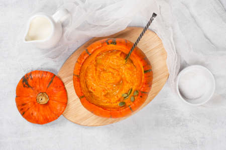 Traditional pumpkin soup in the plate of whole small pumpkin, top viewの写真素材