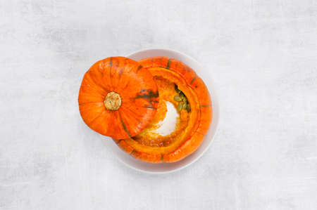 Traditional pumpkin soup in the plate of whole small pumpkin, top viewの写真素材