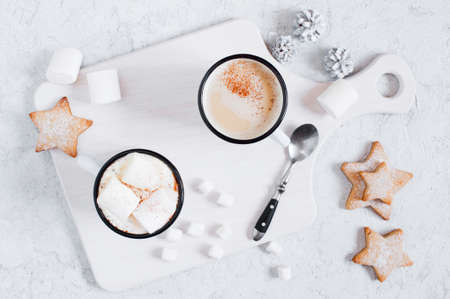 Two white mugs of hot cocoa with marshmallow, light backgroundの写真素材